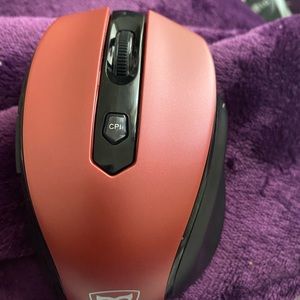 A pink wireless mouse with usb to plug into laptop
